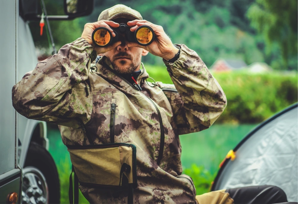 hunter looking through binoculars