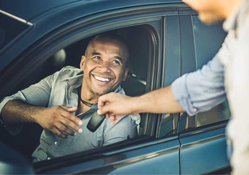 man grabbing keys to car